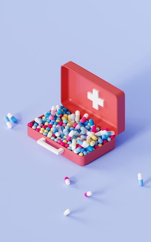 First-aid kit filled with colorful medicine tablets and capsules